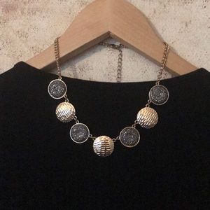 gold and shiny black necklace